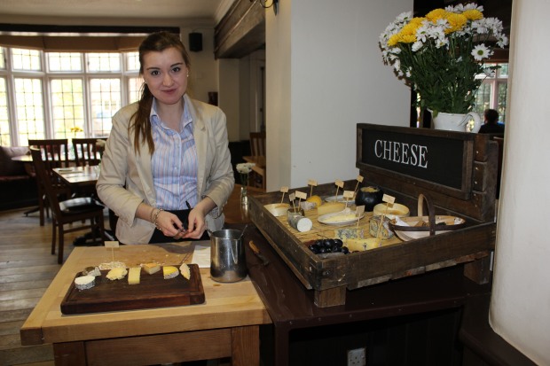 A waitress serving the cheese selection at The Plough Inn, a pub in the village of Longparish